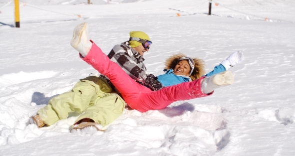 Young Couple Enjoying a Frolic In The Snow