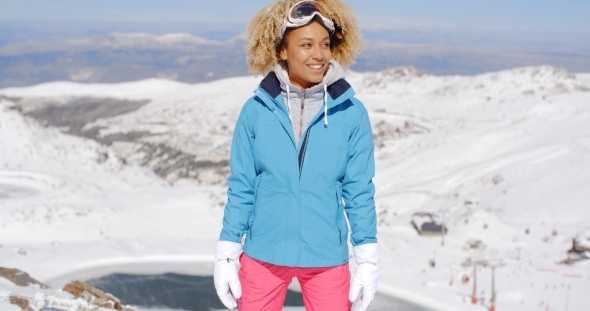 Beautiful Woman In Ski Outfit Standing On Mountain
