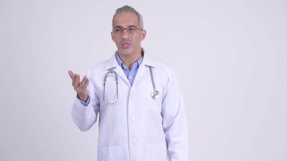 Happy Persian Man Doctor Talking Against White Background