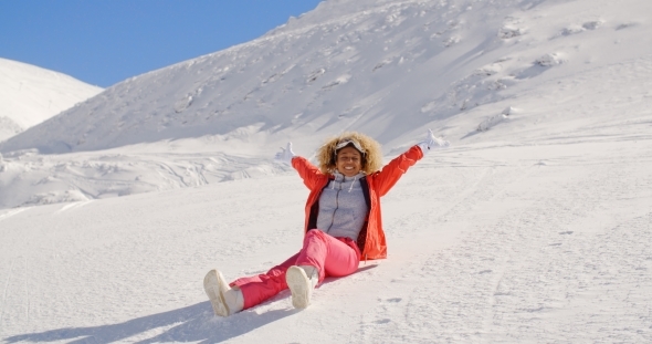 Rejoicing Woman Sliding Down Snowy Hill