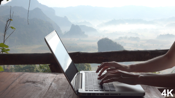 Woman Using Laptop Computer On Mountain Background