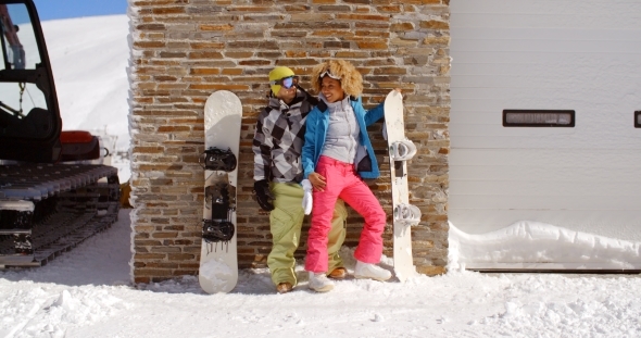 Cute Couple Leaning Against Ski Resort Garage