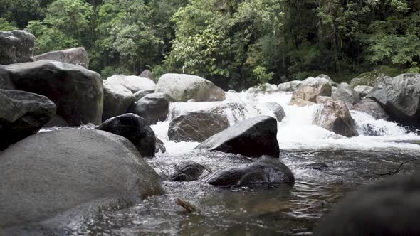 Slow motion river Stream in a tropical forest with a small waterfall