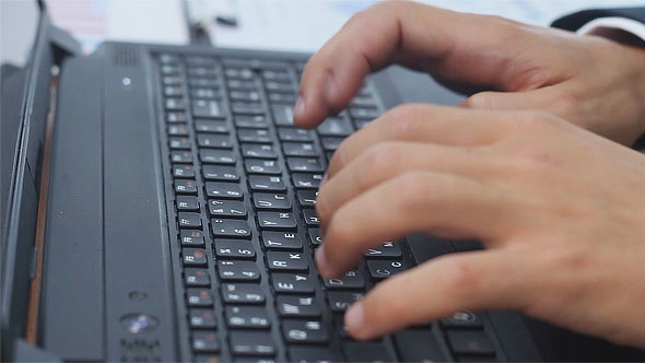 Man Typing on Laptop alt