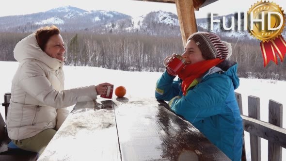 Two Women in The Winter, at a Picnic, Drinking