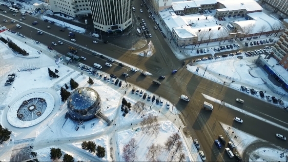 Flying Over The City Park In Winter Car Traffic