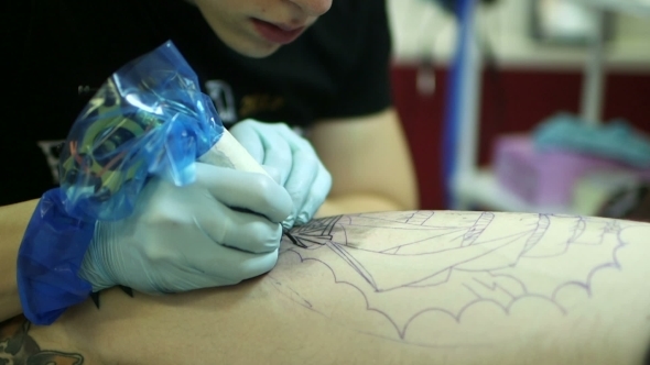 Tattooer Showing Process Of Making A Tattoo