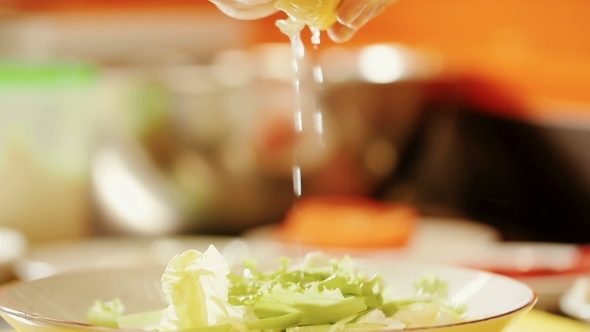 Squeezing Lemon Juice On The Salad Greens.