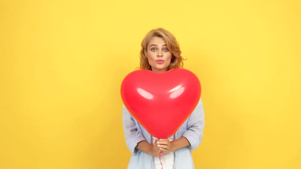 Happy Woman Blow Kiss and Wink Behind Heart Love Party Balloon Love