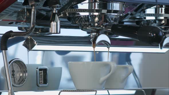 Coffee Pouring Into White Ceramic Cups From Coffee Machine