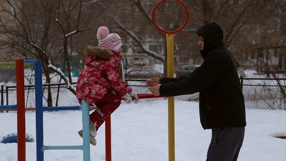 Girl Playing on the Sports Playground in Winter