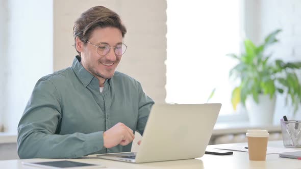 Middle Aged Man Talking on Video Call on Laptop