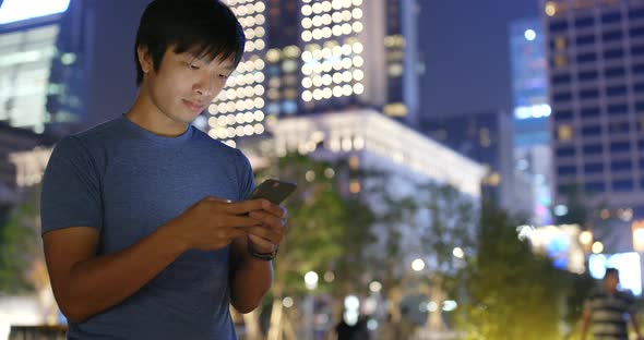 Young man use of cellphone at night