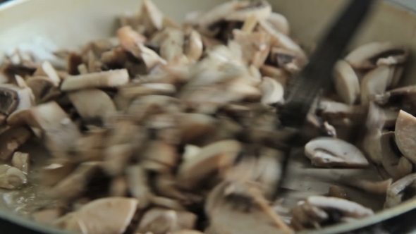 Woman Cooking And Stirring Mushrooms