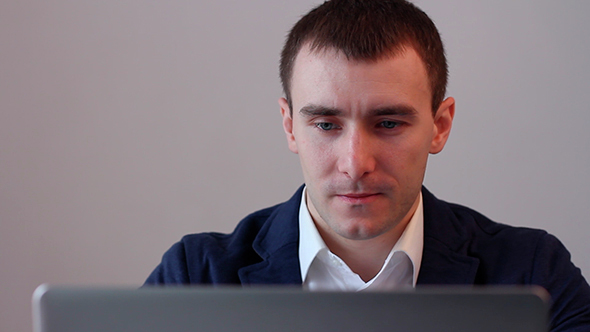 Young Man Working On Laptop