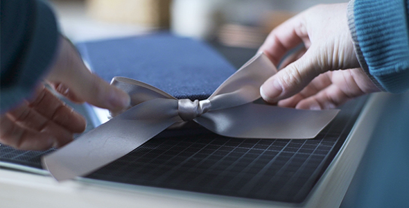 Bookbinder Ties A Ribbon On Handmade Album Book