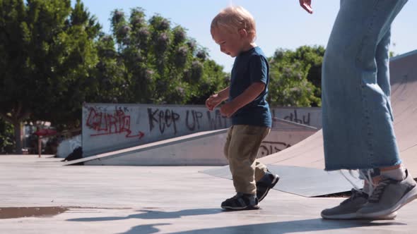 Family Spending Time with His Little Son in the Skatepark
