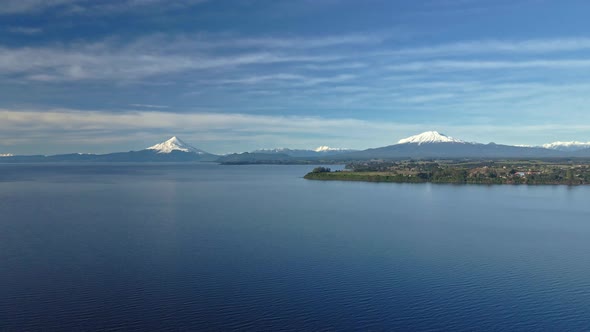 Aerial view truck left of Lake Llanquihue with the Calbuco and Osorno volcanoes in the background.