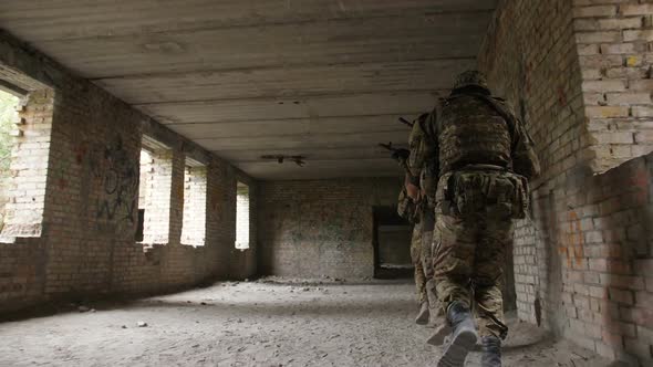 Soldiers in Camouflage Investigating Territory