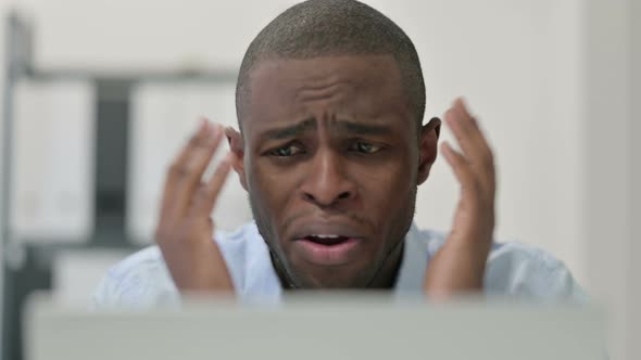Close Up African Man Having Loss While Using Laptop