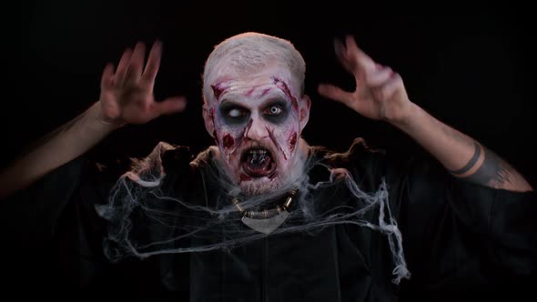 Sinister Man Scary Halloween Zombie Making Playful Silly Facial Expressions Grimacing Fooling Around