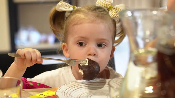 a Little Girl Eats Chocolatecovered Marshmallows