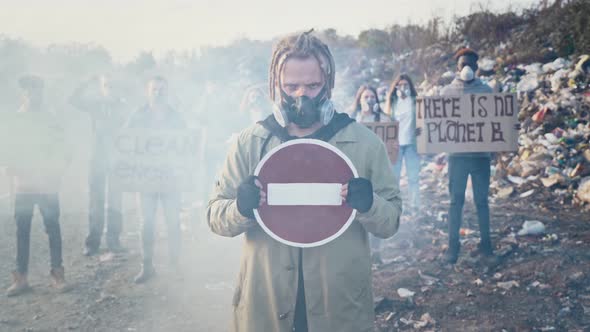 Young Man Activist Holding Stop Sign Going With Fighting People Protesting Against Garbage Pollution