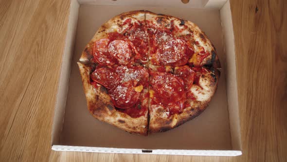 Hands Taking Pieces of Traditional Italian Pizza From Delivery Open Box Food Delivery Service to