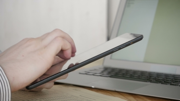 Freelancer Typing On Tablet PC in Modern Office, Close Up