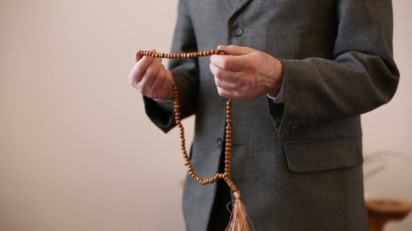 Praying Hands With Rosary Beads Of An Old Man