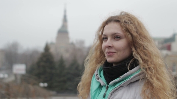 Blonde Girl In Grey Jacket Smiles In City