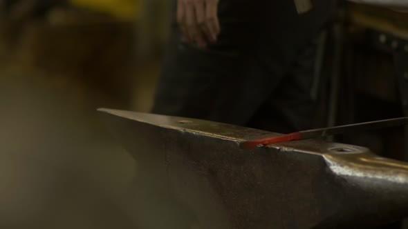 Blacksmith Forges A Red-Hot Iron In The Forge
