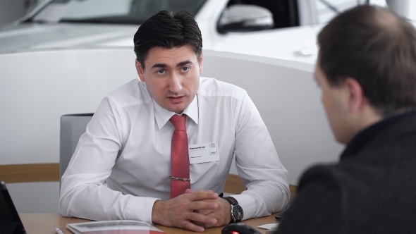 The Manager Conducts a Dialogue With The Customer In The Car Shop. 