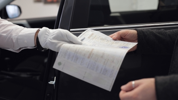 Customers Signing Some Important Documents At New Car Showroom