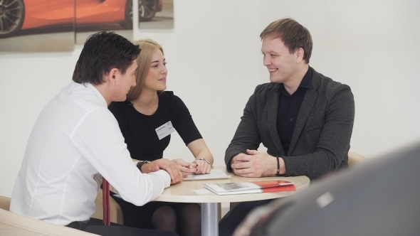 Business Woman And Businessman Communicate With The Client. 