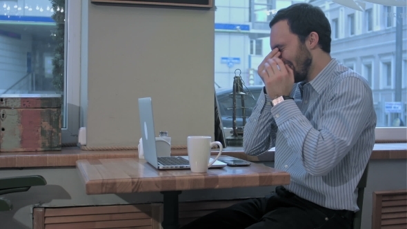 Emotional Freelancer Man With Laptop Yawns Early In The Morning In Cafe,