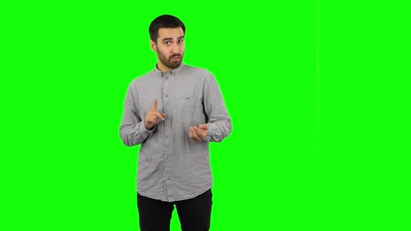 Brunette Guy Is Talking About Something Then Making a Hush Gesture, Secret. Green Screen