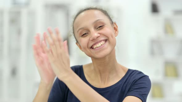 Portrait of Excited Young African Woman Clapping 