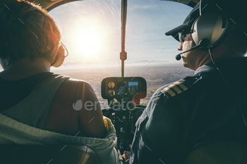 Man flying a helicopter with his copilot