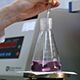 Scientist Examining Sample and Mix Liquid in Flask - VideoHive Item for Sale