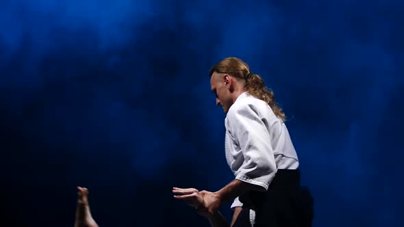 Two Fighters Participants of the Training in Special Clothes of Aikido Hakama Work Out the Methods