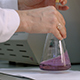 Examining Sample and Mix Magenta Liquid in Flask - VideoHive Item for Sale