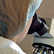 Researcher viewing through microscope - VideoHive Item for Sale