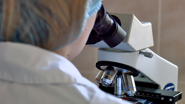 Doctor Scientist Viewing Through Microscope