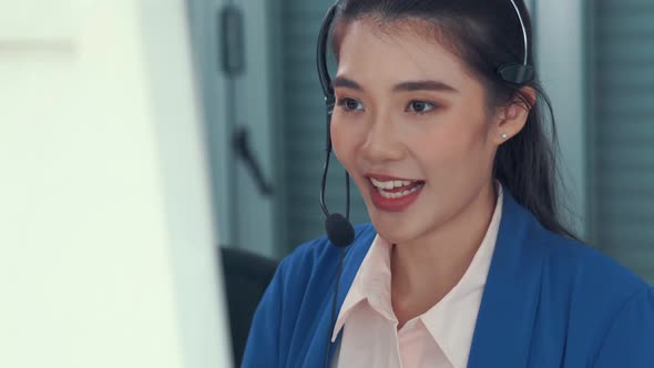 Businesswoman Wearing Headset Working Actively in Office