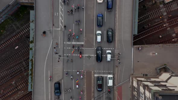 Aerial Birds Eye Overhead Top Down Panning View of Large Group of Cyclists Participating on