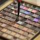 Woman Dabs a Small Brush into a Makeup Palette - VideoHive Item for Sale