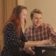 Young Couple Laughing At Laptop - VideoHive Item for Sale