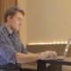 Young Man Working At a Laptop At Home - VideoHive Item for Sale