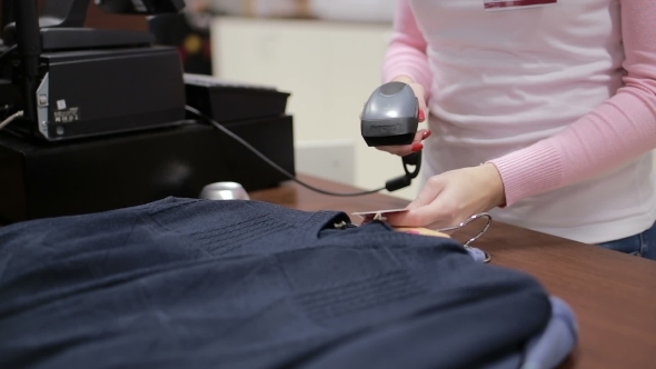 Seller Checks The Price At The Cash Register